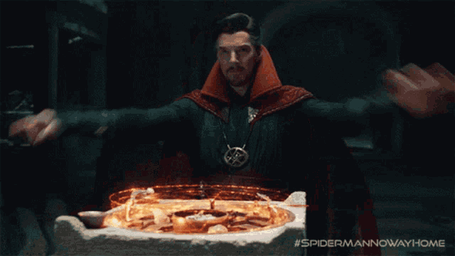 a man in a red cape stands in front of a circle of fire with the words #spidermannowwayhome below him
