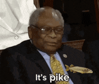 a man in a suit and tie is holding a fish in his pocket and saying it 's pike