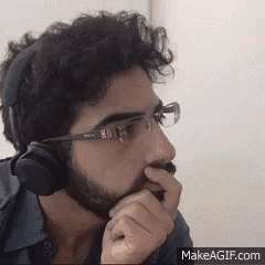 a man wearing headphones and glasses is thinking