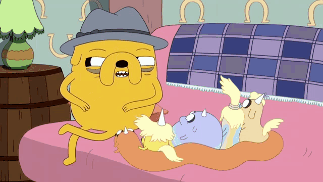 a cartoon character with a hat is laying on a bed with two other cartoon characters