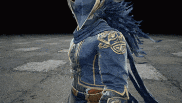 a man in a blue and gold armor with a hood