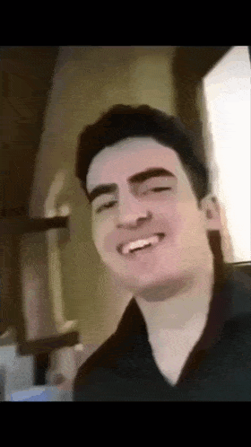 a close up of a man 's face with a smile on his face