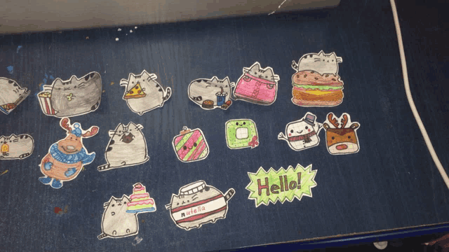 a bunch of drawings on a table with one that says hello