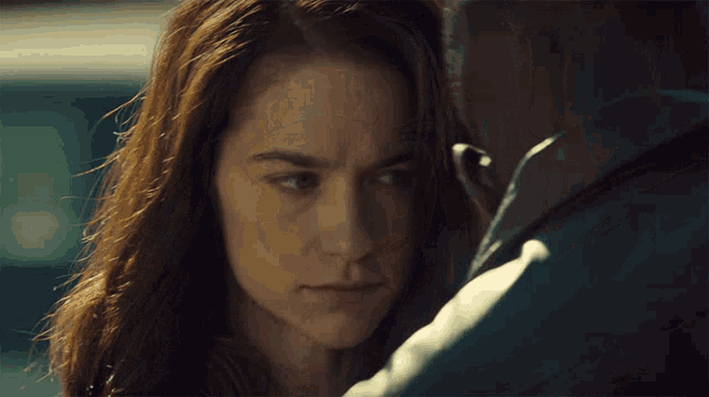 a close up of a woman looking at a man 's face