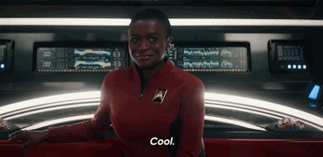 a woman in a red jacket with the word cool on it