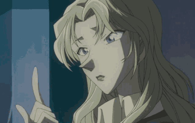 a woman with blonde hair and blue eyes is pointing her finger up