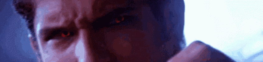 a close up of a man 's red eyes in a dark room .