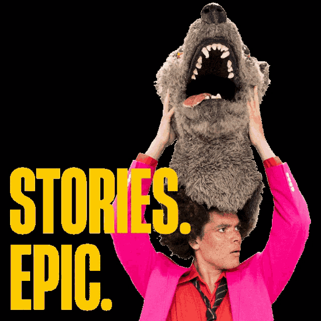 a man in a pink jacket is holding a stuffed wolf on top of his head with the words stories epic below him