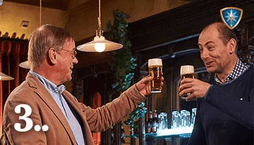 two men toasting in a bar with the number 3 on the bottom right