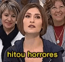 a group of women are posing for a picture and one of them has the word hitou horrores on her shirt