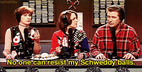 a man and two women are sitting at a table with microphones and a sign that says no one can resist my schweddy balls .