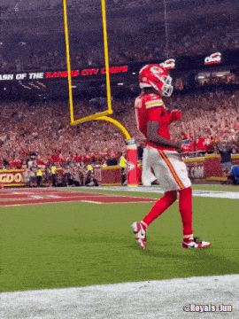 a kansas city chiefs player celebrates a touchdown on the field