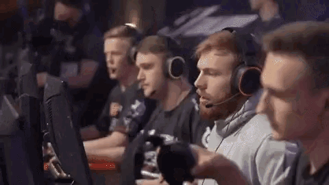 a group of men wearing headphones are playing a game