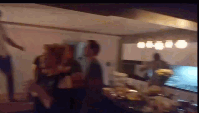 a blurry picture of people in a kitchen