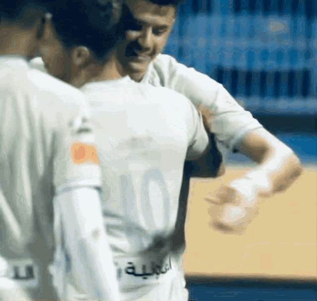 a soccer player with the number 10 on his back is hugging another player