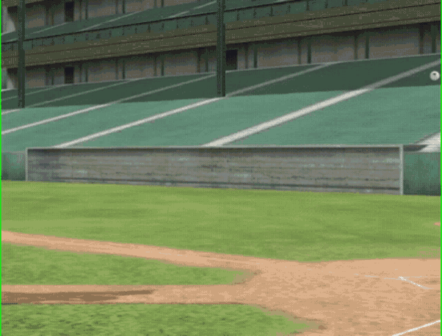an empty baseball field with a concrete wall in the middle