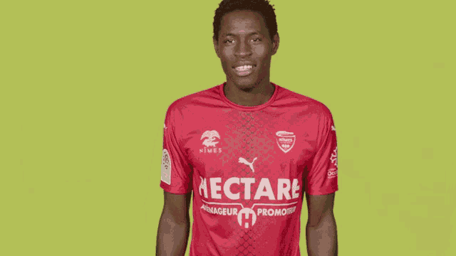 a man is wearing a red shirt that says nectare