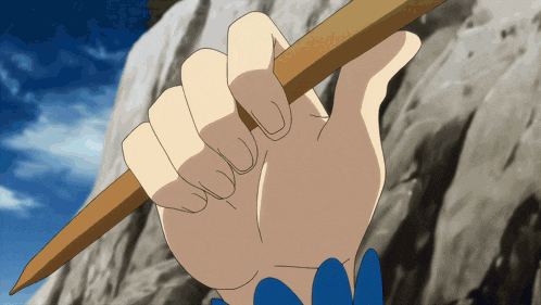 a person 's hand is holding a wooden stick in their left hand