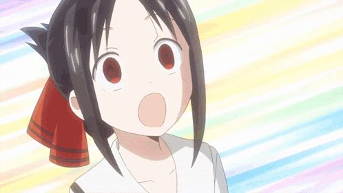 a close up of a girl making a funny face with her mouth open .