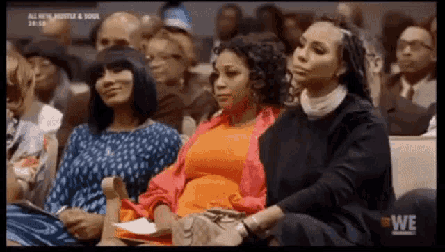 a group of women are sitting in a row in a church .