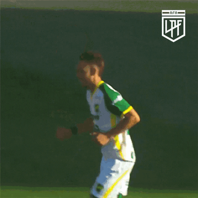 a soccer player wearing a green and yellow uniform with the letters afa on the bottom