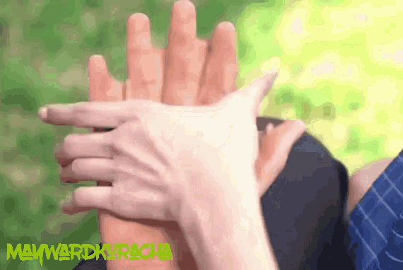 a person 's hands are stacked on top of each other with a green watermark that says mavwardkracha