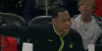 a man wearing a nike jacket with a basketball logo on it