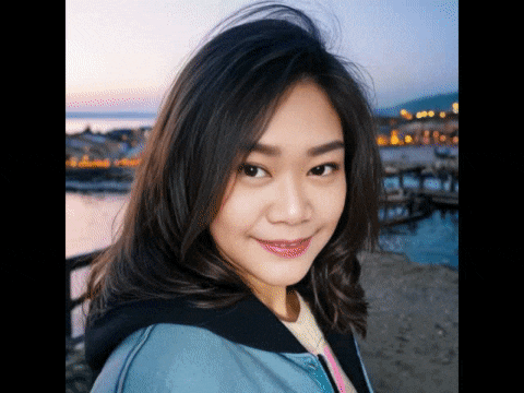 a woman in a blue jacket is smiling and looking at the camera
