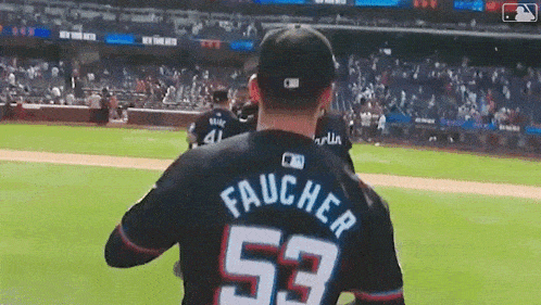 a baseball player wearing a jersey with the number 53 on it
