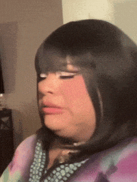 a close up of a woman 's face with a wig