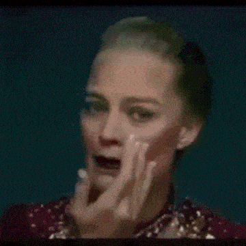 a woman is crying and covering her face with her hands .