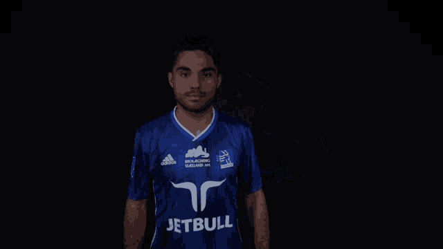 a man is wearing a blue jersey with the name corlu on it