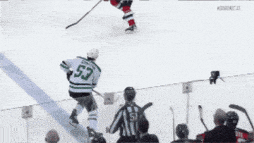 a hockey player with the number 53 on his jersey is skating on the ice