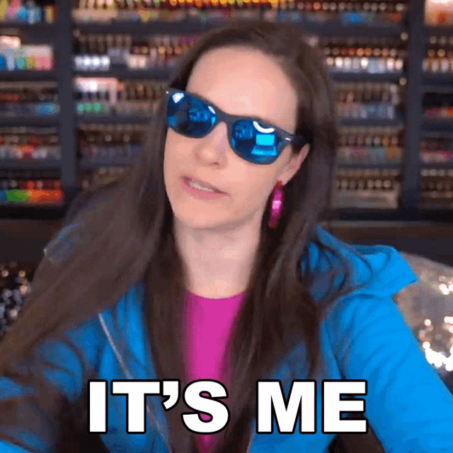 a woman wearing blue sunglasses and a blue jacket says it 's me