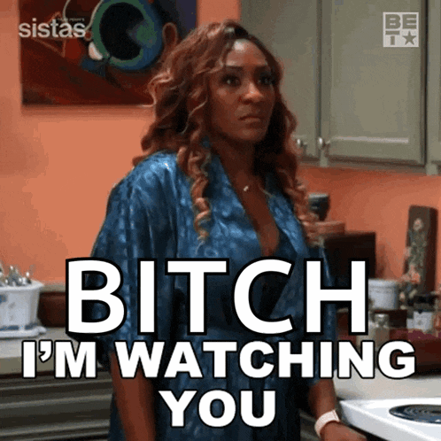 a woman says bitch i 'm watching you while standing in a kitchen