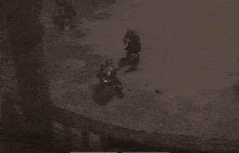 an aerial view of a video game scene with a man and a statue