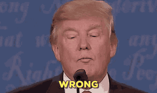 donald trump is giving a speech and says wrong in front of a microphone