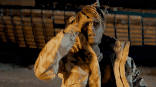 a man with a bandana on his head and a jacket on