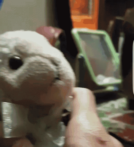 a person is holding a stuffed animal that looks like a rabbit