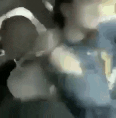 a group of people are standing next to each other in a room in a car .