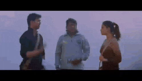 a man and a woman are standing next to each other talking .