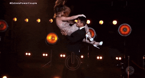 dany hypolito fabio is holding a woman in his arms on a stage
