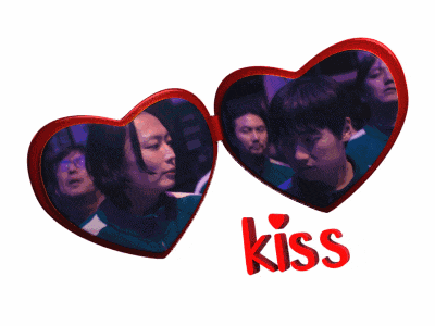 a couple of red hearts with the word kiss on it