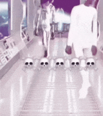 a person is walking down a hallway with skulls on the floor