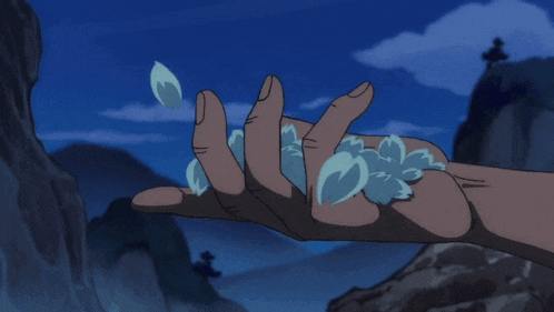 a person 's hand is holding a pile of water