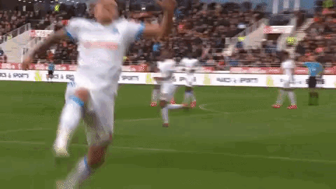 a soccer player is jumping in the air while playing a game