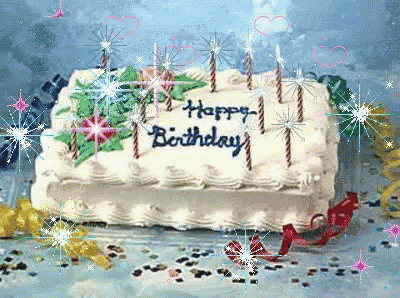 a birthday cake with candles and the words happy birthday written on it