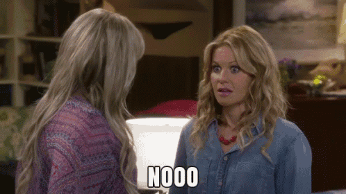 two women are standing next to each other and one of them is saying nooo .