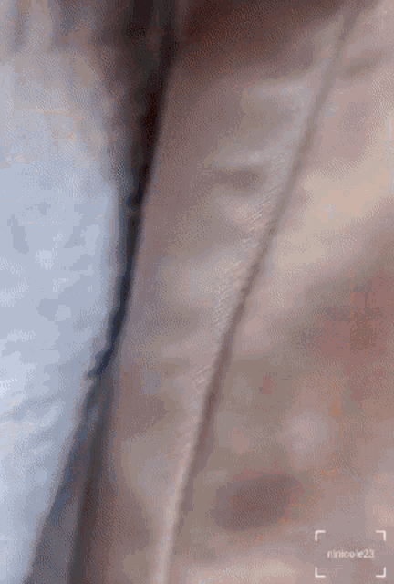 a close up of a piece of fabric with the name rinikoe23 on it