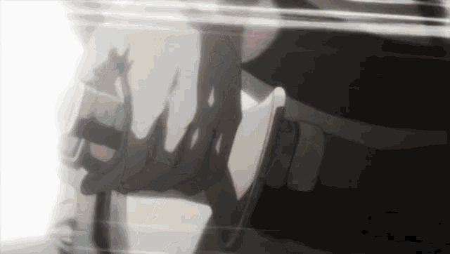 a close up of a person holding a sword in their hand .